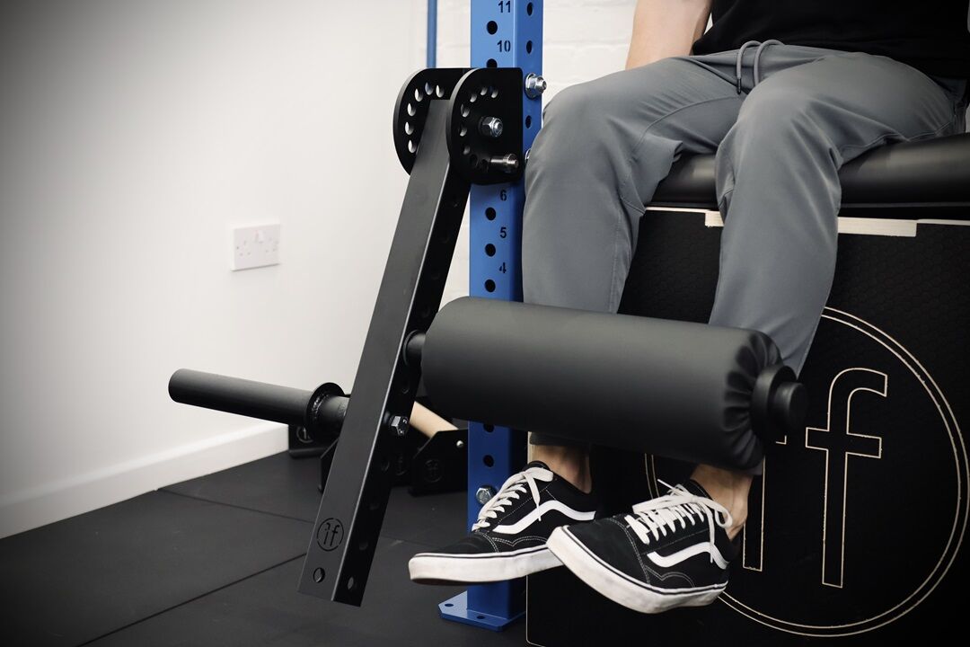 extension. man performing a leg extension exercise