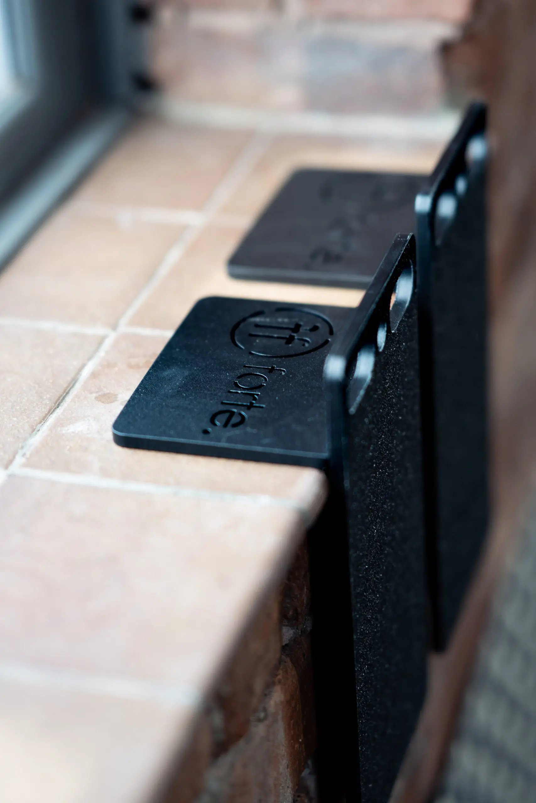 Slant doubles Pair of Forte Fitness slant doubles hanging on a brick wall inside a gym