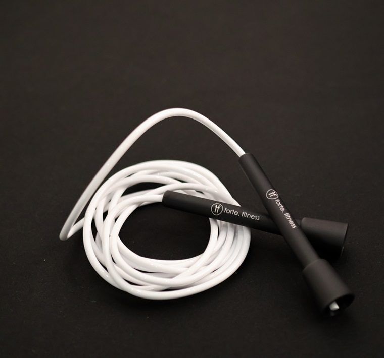 white White vinyl skipping rope with Forte Fitness handles, on the floor