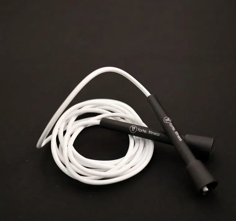 white White vinyl skipping rope with Forte Fitness handles, on the floor
