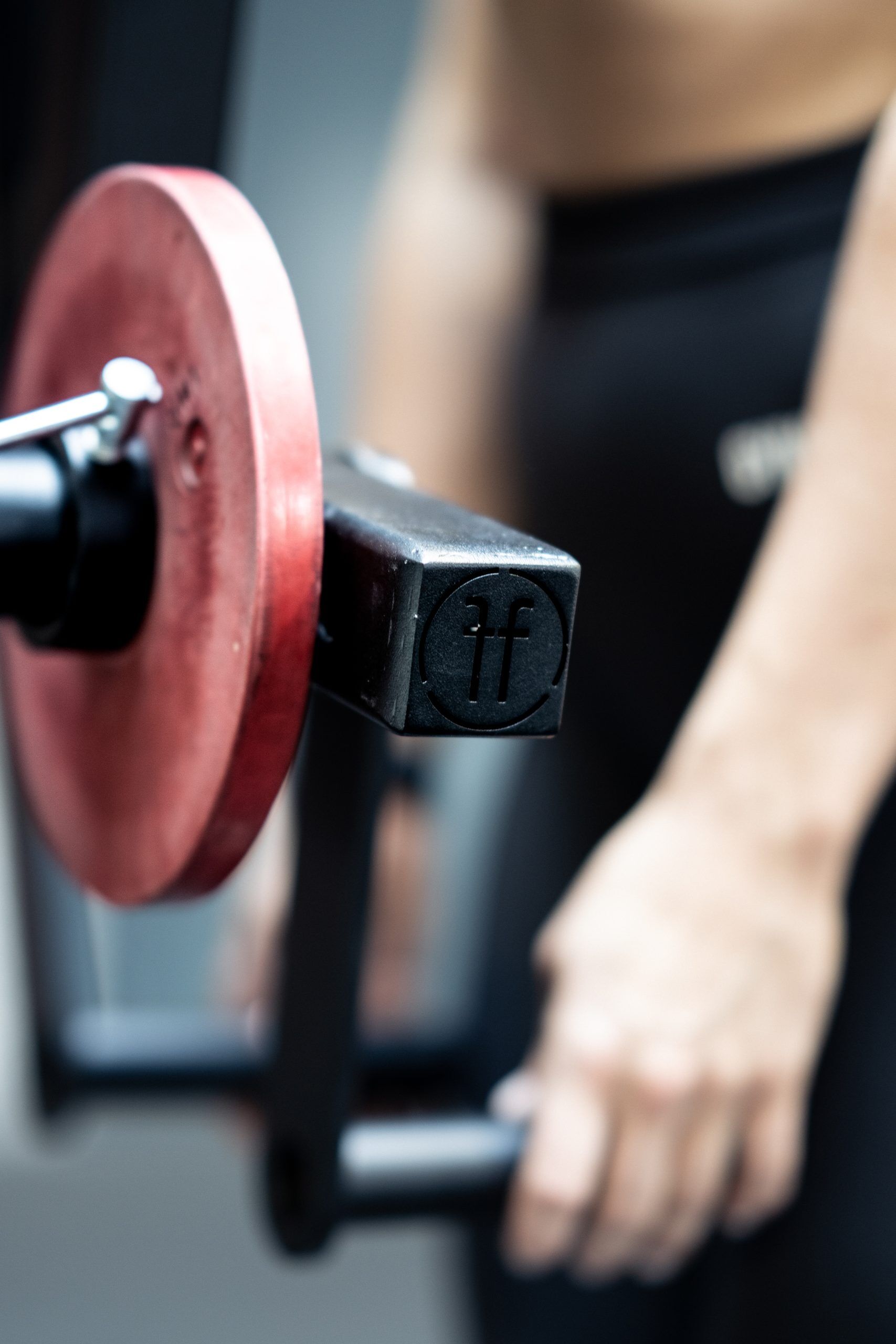lateral raise. close up of a woman doing a lat raise with a lateral raise rack attachment