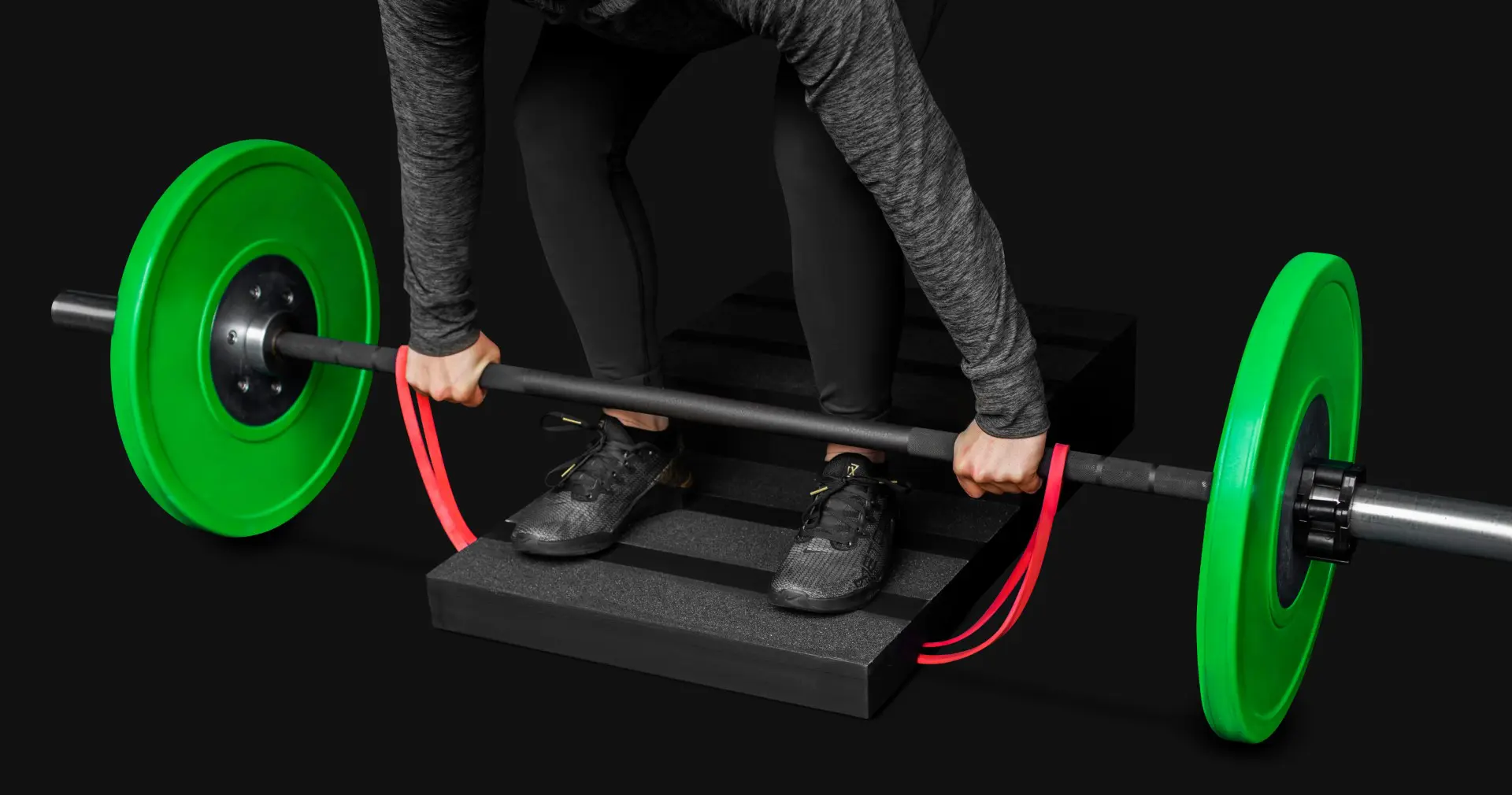 step4 (Grande) close up of a woman performing a banded deficit deadlift on a step board