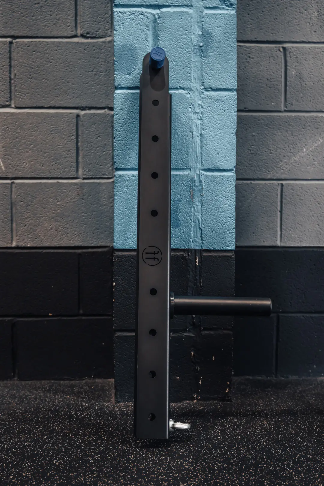 belt squat. photo of a belt squat attachment in a gym resting on a wall