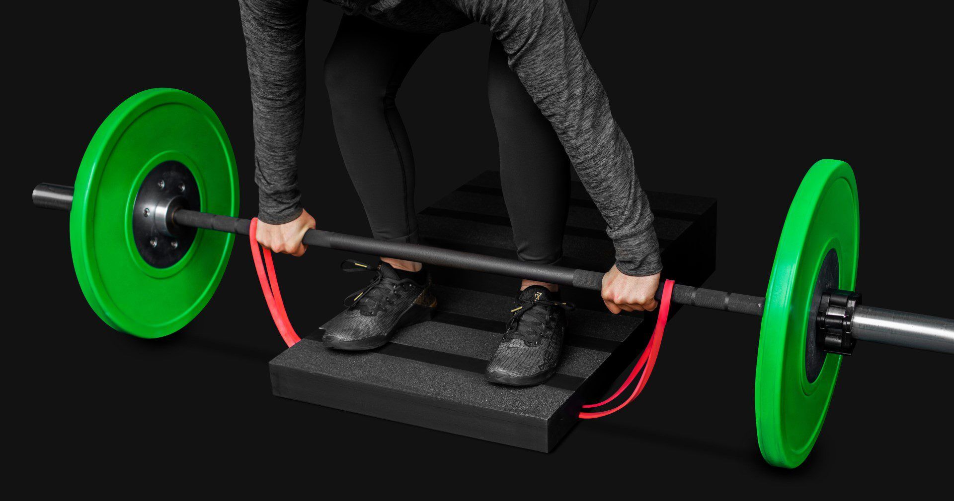 step4 (Grande) close up of a woman performing a banded deficit deadlift on a step board