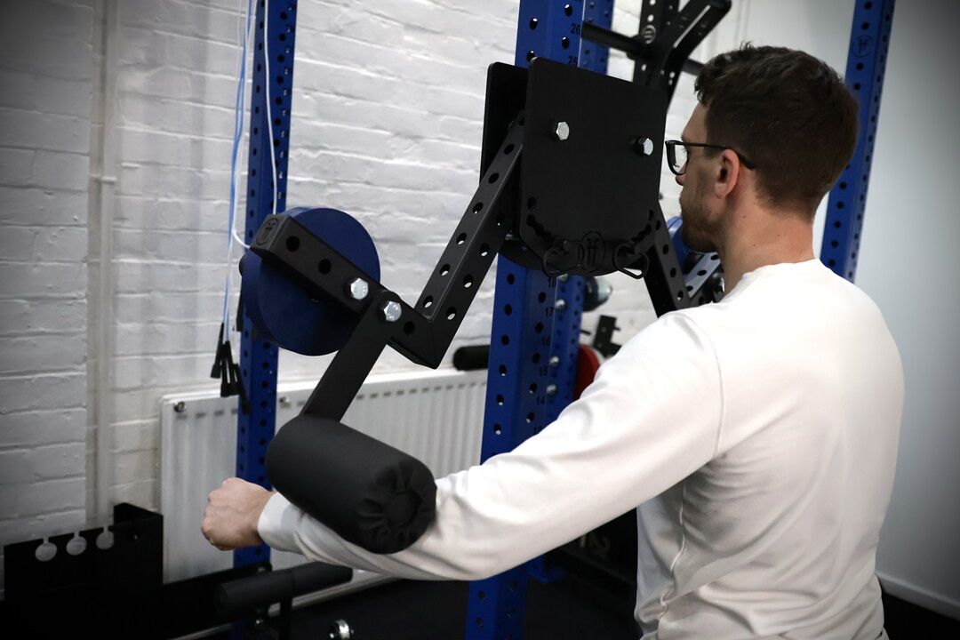 lateral raise. man performing a lateral raise with a rack attachment